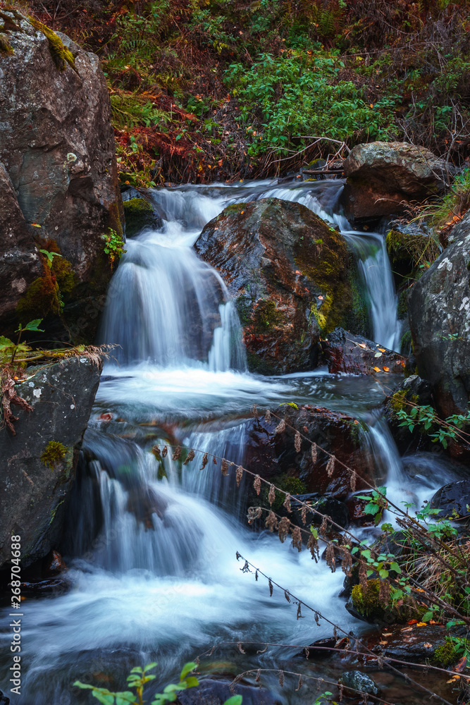 Fototapeta premium Scenic waterfall view in Dariali gorge in autumn, Gveleti waterfall, Georgia