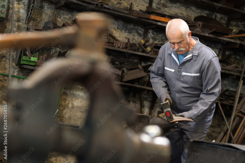 senior man working in a metal factory