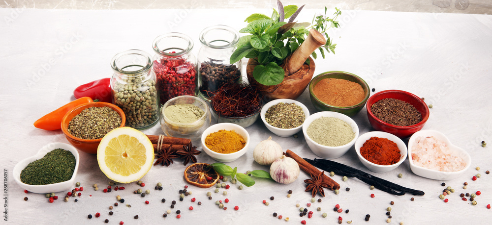 Fototapeta Spices and herbs on table. Food and cuisine ingredients with basil