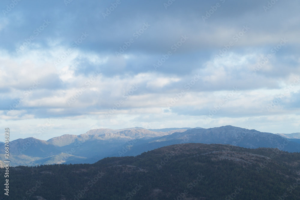 Mountain Ridge with dramatic clouds and skies and sun beams Mountain Ridge with dramatic clouds and skies and sun beams