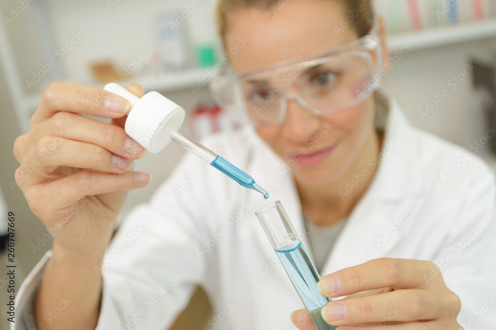 science student using pipette in the lab at the university science student using pipette in the lab at the university