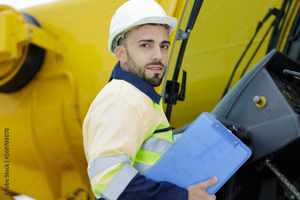 man with hard helmet and clipboard