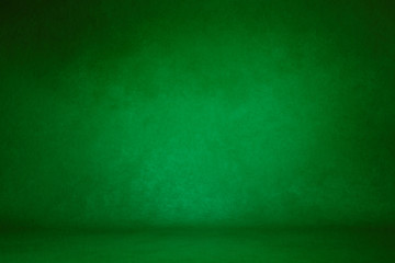 photo background green. textured wall rolling in the floor. studio photography background illuminated by the directed light Traditional painted canvas or muslin fabric cloth studio backdrop