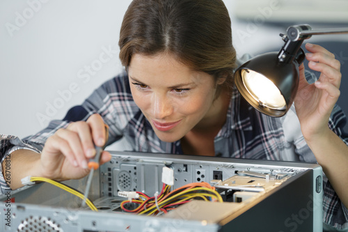 woman fixes pc component in service center