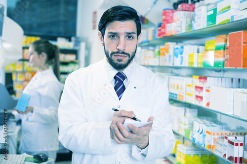 guy pharmacist is inventorying medicines