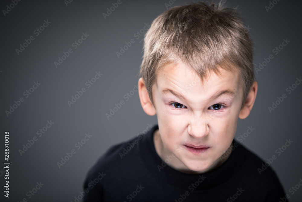 Loads of aggression in a little boy - education concept hinting behavioral problems in young children (shallow DOF) - little boy with hands clenched into fists about to punch someone Loads of aggression in a little boy - education concept hinting behavioral problems in young children (shallow DOF) - little boy with hands clenched into fists about to punch someone