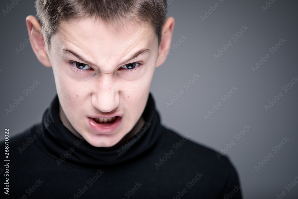 Loads of aggression in a little boy - education concept hinting behavioral problems in young children (shallow DOF) - little boy with hands clenched into fists about to punch someone Loads of aggression in a little boy - education concept hinting behavioral problems in young children (shallow DOF) - little boy with hands clenched into fists about to punch someone