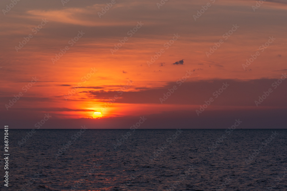 Glowing orange sunset over water