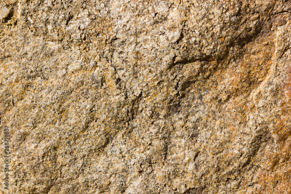Background of granite. Texture of granite stone. Pattern of roughened surface. Texture of brown stone Background of granite. Texture of granite stone. Pattern of roughened surface. Texture of brown stone
