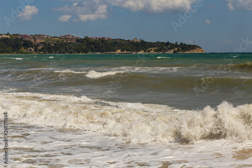 Fototapeta Naklejka Na Ścianę i Meble -  Rest on the Black Sea coast in Bulgaria. The town of Byala in the bright sunlight. European recreation area.  Waves during a storm. Red code. 
