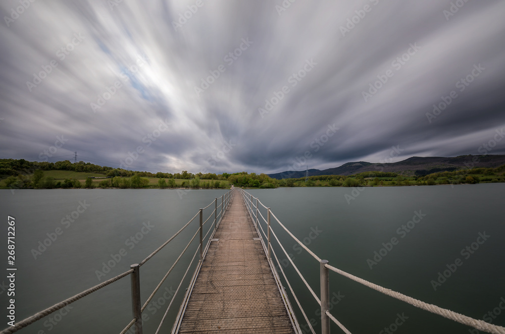 Fototapeta premium Footbridge to nowhere, end point, next step,water
