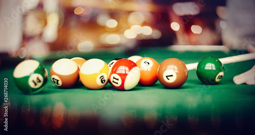 Colorful billiard balls on a billiard table.