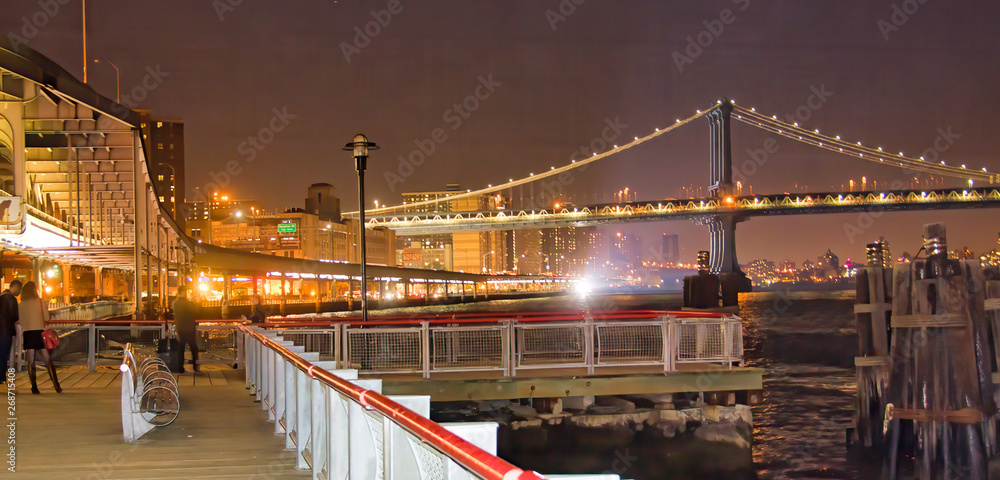 Pier 17 in new York City at night with city skyline view