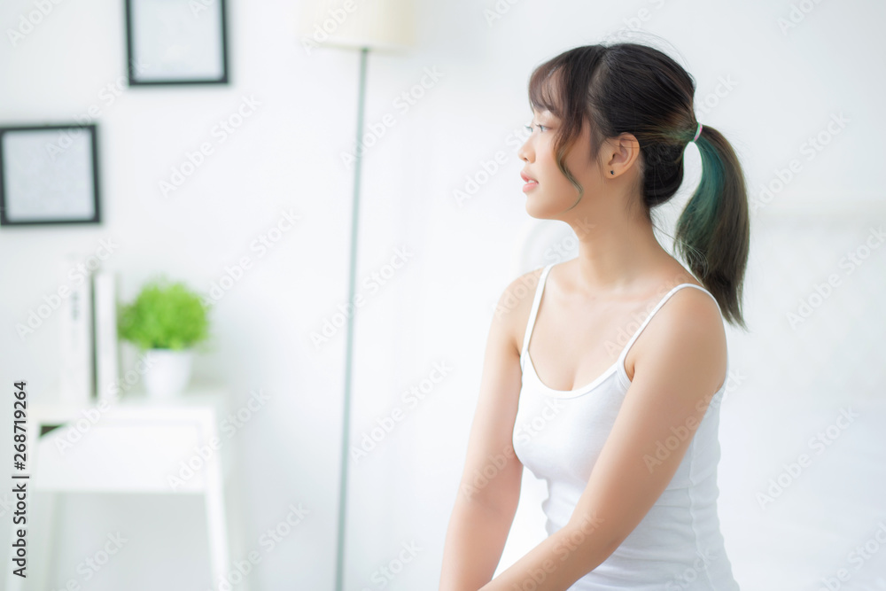 Portrait of beautiful young asian woman smile while wake up healthy and wellness with sunrise at morning in the bedroom, asia girl skin care with happy with fresh, lifestyle and relax concept. Portrait of beautiful young asian woman smile while wake up healthy and wellness with sunrise at morning in the bedroom, asia girl skin care with happy with fresh, lifestyle and relax concept.