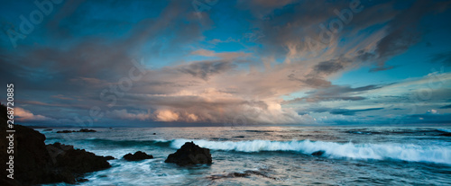 sunset over rocky coastline of california