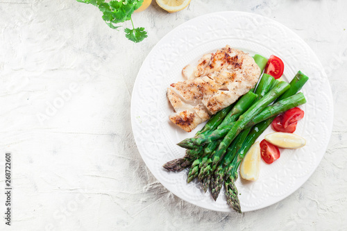 Fried cod fillet with green asparagus