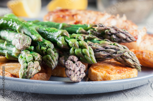 Fried cod fillet with green asparagus