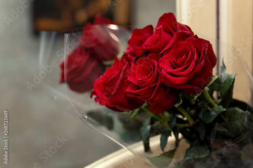 Bouquet of five red roses reflecting on mirrorA bunch of red roses