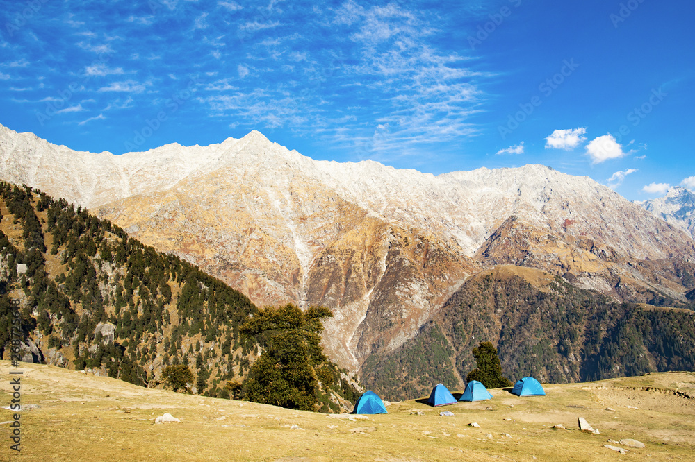 Blue tents in the foreground and beautiful peaks of the Himalayas Mountains  in the background. Sunny day with some clouds. Dharamshala, Himachal Pradesh,  India Stock Photo | Adobe Stock