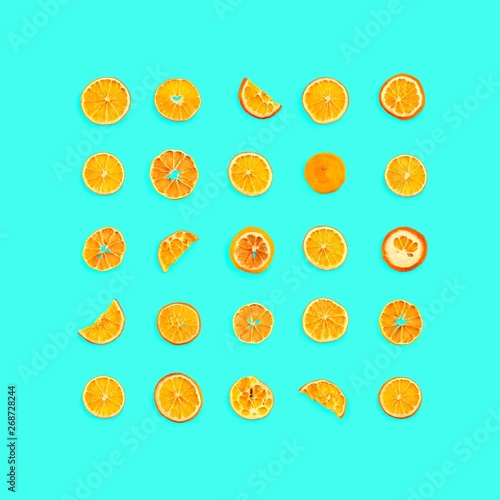 Set of dried slices and half a slice of orange and lemon as background, isolated on blue background