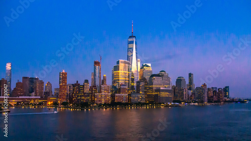 New York City Skyline with Skyscrapers Illuminated at Dusk © heyengel