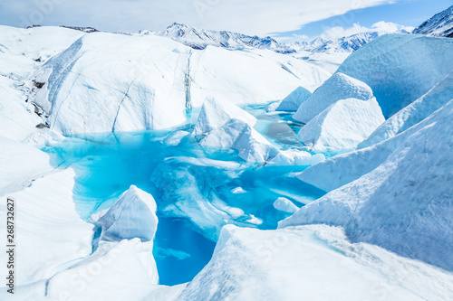 Deep blue pool of flooded ice cave on the Matanuska Glacier in Alaska's Chugach Range.