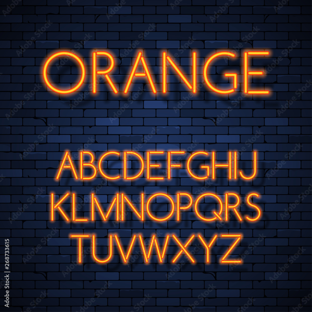 Obraz premium Glowing neon alphabet on brick wall background
