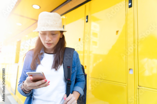 Woman traveler using smartphone for vacation in the city