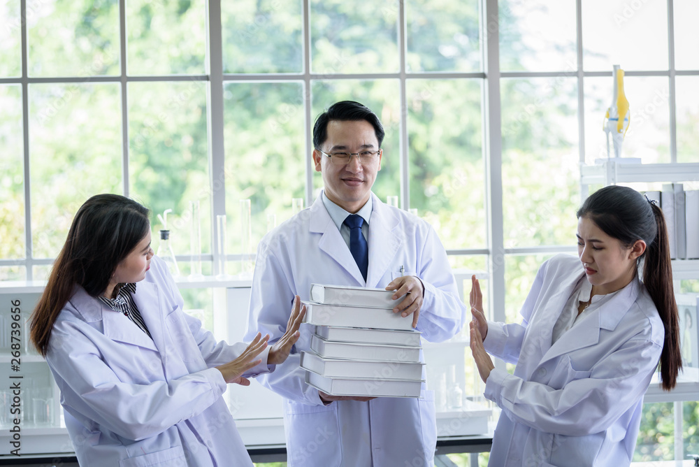 Senior asian scientist has assigning new job to students in laboratory. Senior asian scientist has assigning new job to students in laboratory.
