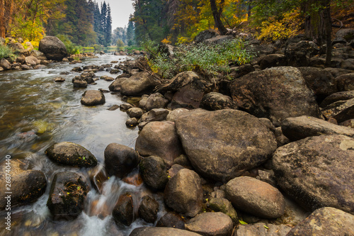 Water flowing over rock on Merced River in Yosemite Vally in the Autumn