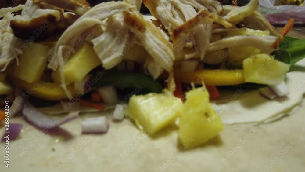 Preparing fresh chicken and vegetable wrap sandwiches Preparing fresh chicken and vegetable wrap sandwiches