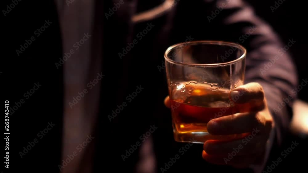 Stock video businessman holding whiskey, a restaurant Stock video businessman holding whiskey, a restaurant