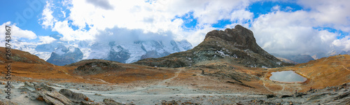 landscape with peaks covered by snow and clouds