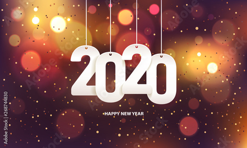 Happy new year 2020. Hanging white paper number with confetti on a colorful blurry background.