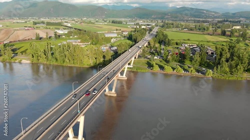 Aerial view of the Mission River bridge with cars travelling over it on a sunny day. photo