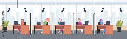 coworkers in creative office women operators sitting at workplace desks call center concept co-working open space interior flat horizontal full length