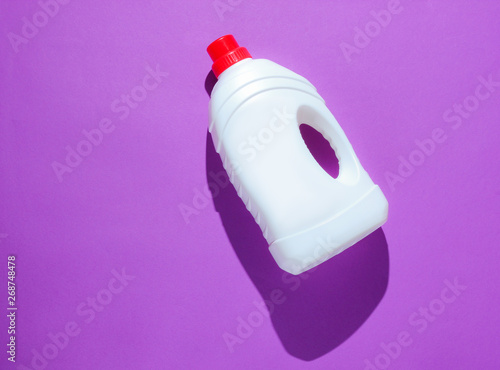 Bottle of washing gel on purple background. Top view
