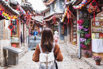 Young woman traveler walking at lijiang old town in China, Travel lifestyle concept