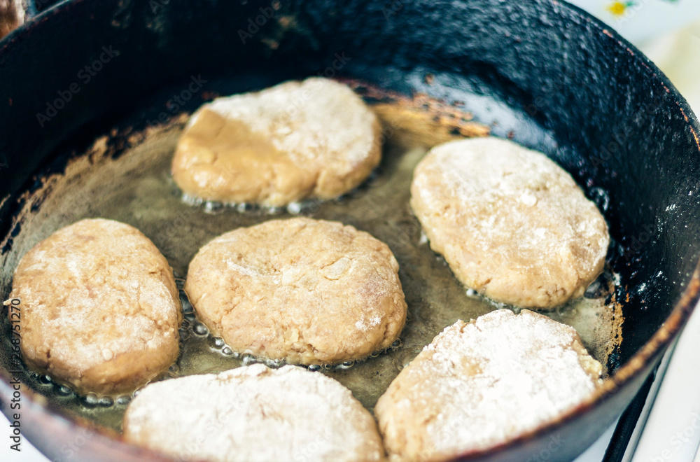 homemade fried minced meat cutlets are roasting in a frying pan in oil. homemade fried minced meat cutlets are roasting in a frying pan in oil.
