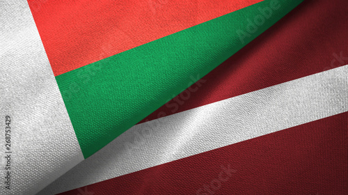 Madagascar and Latvia two flags textile cloth, fabric texture