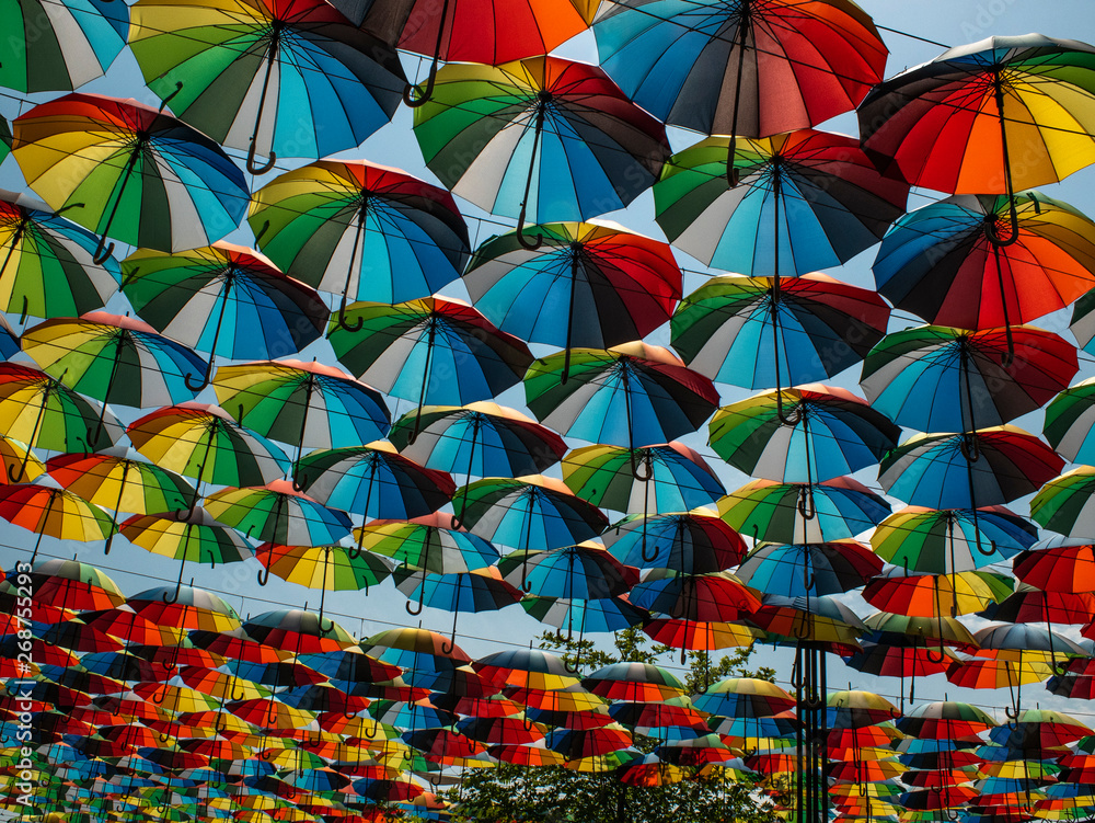 colorful umbrellas outside as decor. umbrellas of different colors against the sky and the sun