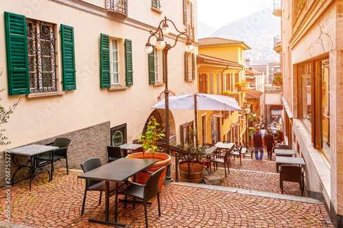 Narrow street with cafes and restaurants in the old town of Lugano, canton of Ticino, Switzerland. photo