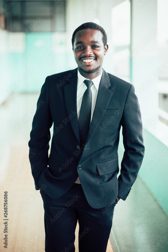African manager owner ceo business man standing confidently African manager owner ceo business man standing confidently
