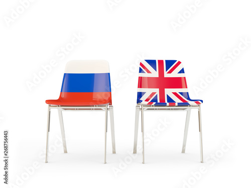 Two chairs with flags of Russia and UK isolated on white