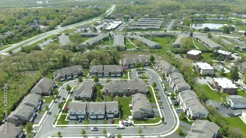 Aerial shot of a modern urban neighborhood in the Midwest, western suburbs of Chicago, near Willowbrook, Illinois. It's a bright and sunny summer afternoon showing and enclosed town home complex photo