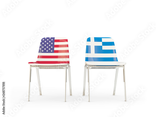 Two chairs with flags of United States and greece isolated on white