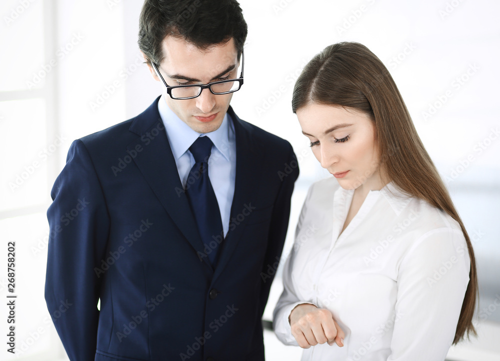 Businessmen and woman using tablet computer in modern office. Colleagues or company managers at workplace. Partners discussing contract. Business concept Businessmen and woman using tablet computer in modern office. Colleagues or company managers at workplace. Partners discussing contract. Business concept