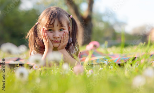 Little girl dreaming in the garden.