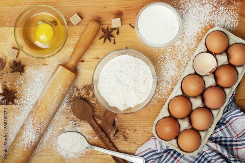 Food ingredients for baking: flour, eggs, milk, sugar 