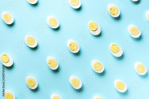 Food concept with boiled eggs pattern on blue background. Top view. Creative pattern in minimal style. Flat lay.